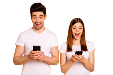 Portrait of his he her she two nice attractive charming stylish trendy cheerful cheery people using new cool chatting gadget device isolated over vivid shine bright yellow background