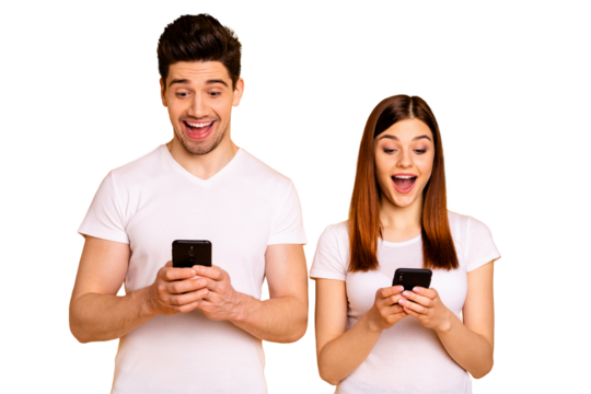 Portrait of his he her she two nice attractive charming stylish trendy cheerful cheery people using new cool chatting gadget device isolated over vivid shine bright yellow background