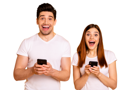 Portrait of his he her she two nice attractive charming lovely stylish cheerful positive people enjoying using new modern gadget device isolated over vivid shine bright yellow background