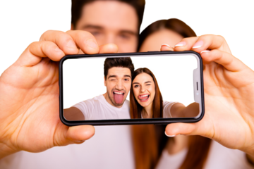 Close-up view portrait of two nice attractive lovely cheerful cheery playful foolish positive people making taking selfie isolated over vivid shine bright yellow background