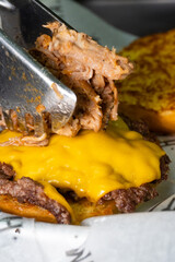 grilled steak with doble cheeseburger and pulled pork