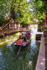 Obraz premium China traditional tourist boats at Shanghai Zhujiajiao town with boat and historic buildings, Shanghai China