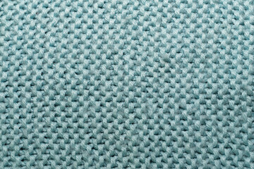 Textured fabric pattern hand-knitted from wool threads.