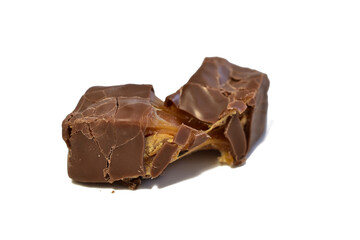 Chocolate candy with caramel filling lies on a PNG background.