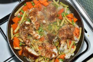 View of cod fish being fried in a frying pan. Top view.