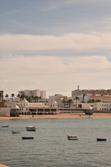 Fototapeta premium View of the beach and boats near the shore from the sea