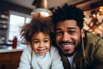 Smiling portrait of a young father and his daughter at modern home