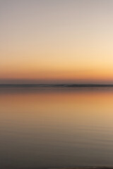 a sunset with a sunset in the background and a beach scene with a beach and trees.
