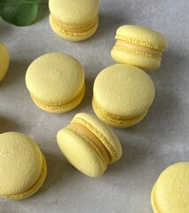 Single Yellow Macaron Close-Up with Smooth Filling