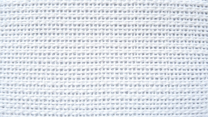 Obraz premium White knitted fabric as background, closeup. Textile texture