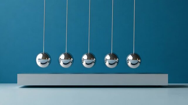 A clean and modern image of five chrome pendulums, demonstrating motion and energy. Ideal for educational materials and presentations in a sleek design. AI