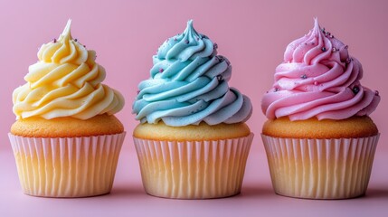Colorful Cupcakes with Swirled Frosting in Pastel Shades of Yellow, Blue, and Pink on a Soft Pink Background for Sweet Treats and Dessert Lovers