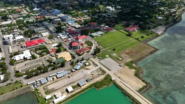 Drone flight over Nuku'alofa, the capital of the Kingdom of Tonga. The building of the royal residence and the sights of the town of Nuku'alofa. Panorama of Tongatapu Island. Cityscape from a bird's e