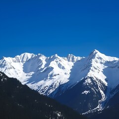 Majestic Snow-Capped Mountain Range in Vibrant Blue Winter Atmosphere  [with copy space]