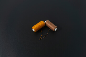 Spun polyester sewing thread on black background