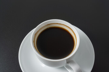 A cup of americano coffee on black background