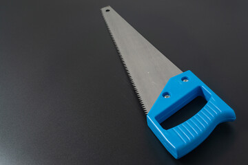 Handsaw on black background