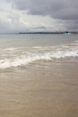 Sea view with small waves in cloudy weather. Balearic Sea, Salou, Spain. View of the waves on the sea from a lower angle. Landscape with sea and clouds