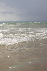 Sea view with small waves in cloudy weather. Balearic Sea, Salou, Spain. View of the waves on the sea from a lower angle. Landscape with sea and clouds