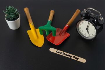 Gardening concept with a text Gardening Day on black background
