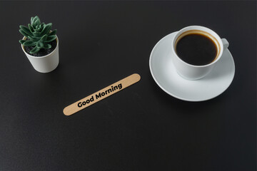 A cup of coffee with a text Good Morning on black background