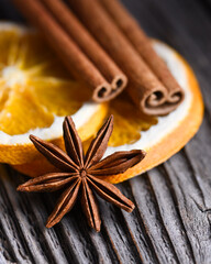 Aromatic Christmas concept with cinnamon sticks, candied orange slices, anise stars close up. Food photography