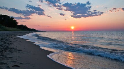 Tranquil Sunset Over Calm Water at Sandy Beach with Colorful Clouds