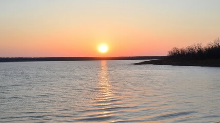 Obraz premium Serene Sunset Over Tranquil Water at Dusk with Golden Reflection