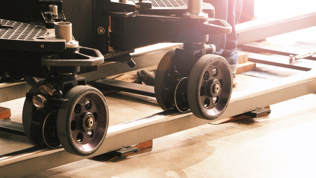 Camera trolley or camera dolly cart rails for filmmaking on studio shooting set. Pro videographer dolly rail track for filming movie mounted on studio floor. Video production dolly and crews in set.