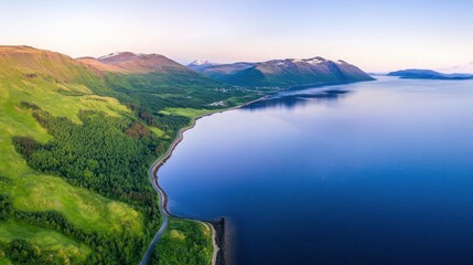 Fototapeta premium Serene Aerial View of Lush Green Mountains and Calm Blue Water Landscape