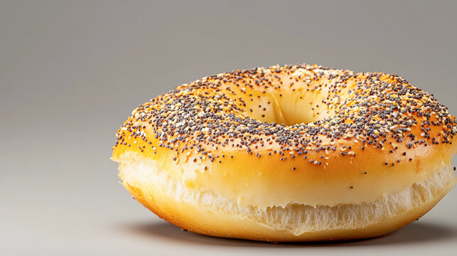 Captivating side profile view of a freshly baked everything bagel, showcasing its delicious toppings against a minimalistic background