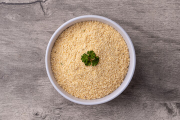 Farofa, typical brazilian manioc flour side dish over wooden table