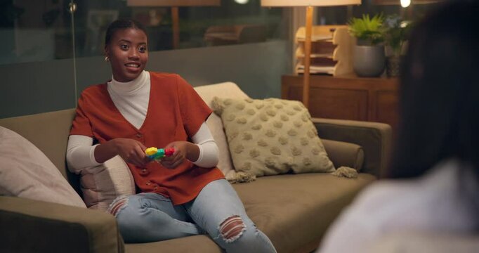 Fidget toy, therapy or happy woman in counseling, help or support for mental health at night in office. Psychology session, consultation or talk to client for autism, adhd or relax for anxiety relief