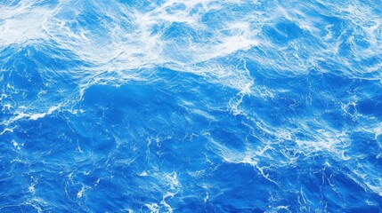 Fototapeta premium Bright Blue Ocean Waves with Foamy Texture Under Clear Sky Background