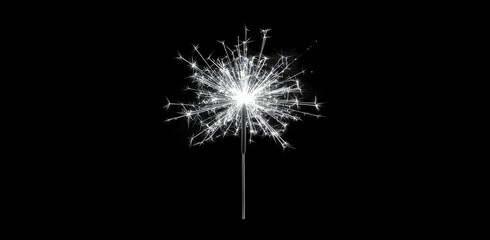 Fototapeta premium Sparkler illuminating a dark atmosphere during a nighttime celebration