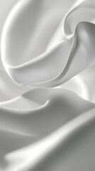 Soft white fabric drapes elegantly with subtle folds and curves in natural light