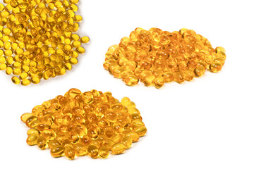 A group of yellow capsules isolated on a white background.