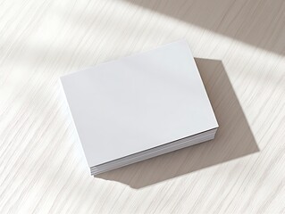 Bright solid color blank business cards neatly placed on a light wood surface with perfect lighting,
