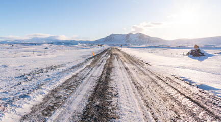 Icelandic road covered with snow during winter, snow removed with tractor or truck snow plough....