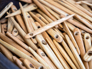 A scattering of large wooden needles. (Shallow depth of field)