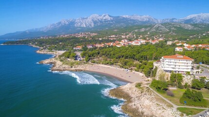 Fototapeta premium Aerial View of Coastal Town Surrounded by Mountains and Scenic Beach