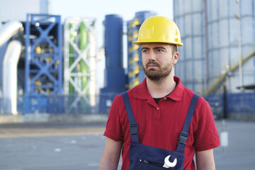 laborer outside a factory working dressed with safety overalls equipment