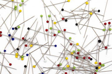 Assorted Colorful Push Pins on White Background – Textured Macro View