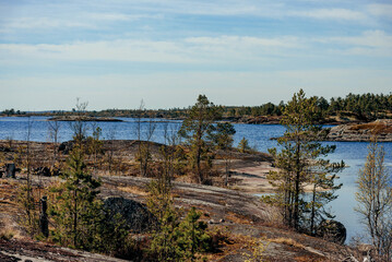 Landscape of blue deep lake in light of sun in daytime, clouds in sky