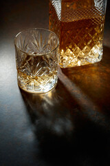 Decanter and cut glass tumbler with whiskey.