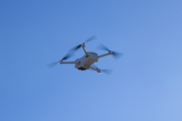 drone flying in cloudy blue sky, copy space.