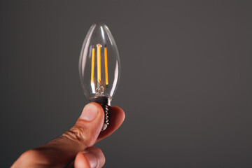 a hand holding a light bulb