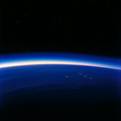 Naklejka premium Earth's curvature illuminated by sunlight against the backdrop of space at twilight