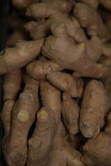 Fresh ginger root. Zingiber. Beige-light brown skin and golden-yellow interior. Ginger is an...
