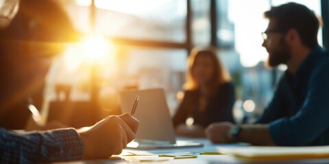 A group of people having a casual meeting in a modern office room filled with sunlight and creativity.